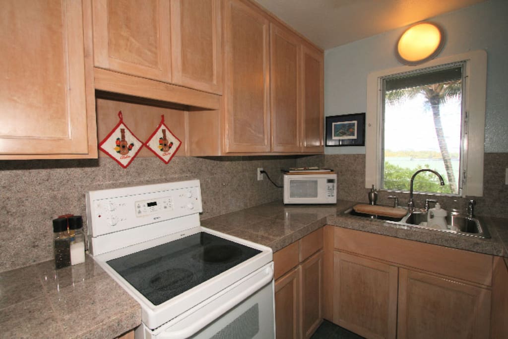 Kitchenette with apartment size appliances and plenty of tools for cooking
