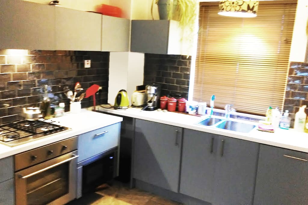 Kitchen - this shows new tiled splash-back behind cooker and sink areas