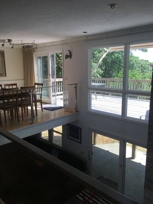 Dining room and downstairs open space living room, connecting to giant back yard and path to dock.
