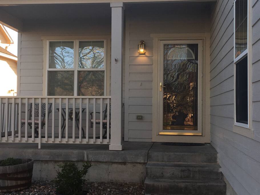 Front porch sitting area and entrance to home.