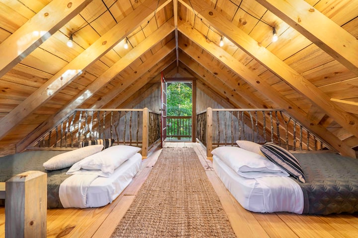 Up the ships ladder are comfy twin beds and a balcony offering the highest views from Trinity Treehouse.
Credit: Dickersonarts.com