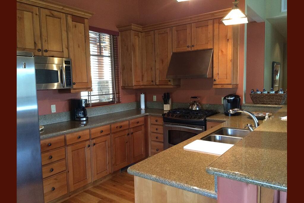 Fully stocked kitchen with pots and pans, utinsels, plates, cups, napkins, etc.
