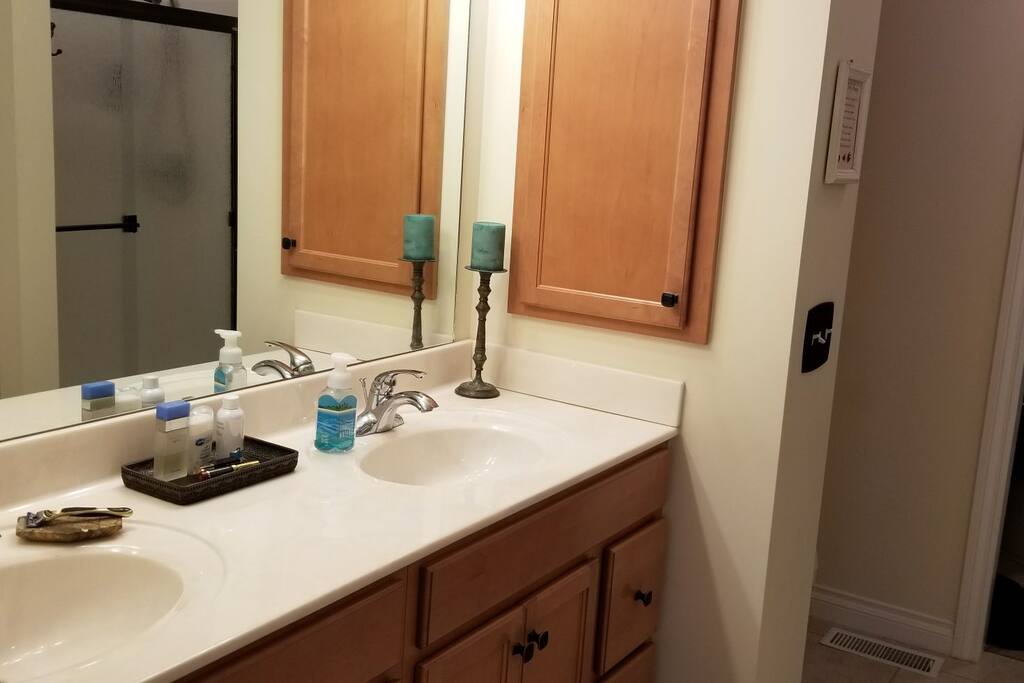 Private, connected master bath with double vanity sinks, walk in shower.
