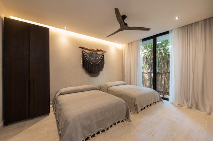 First floor bedroom, with two full size mattress beds, bathroom and acces to the garden. 