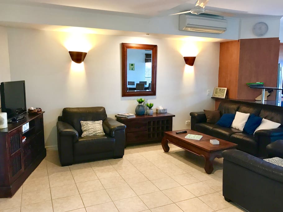 Spacious lounge with comfy chairs and sofa