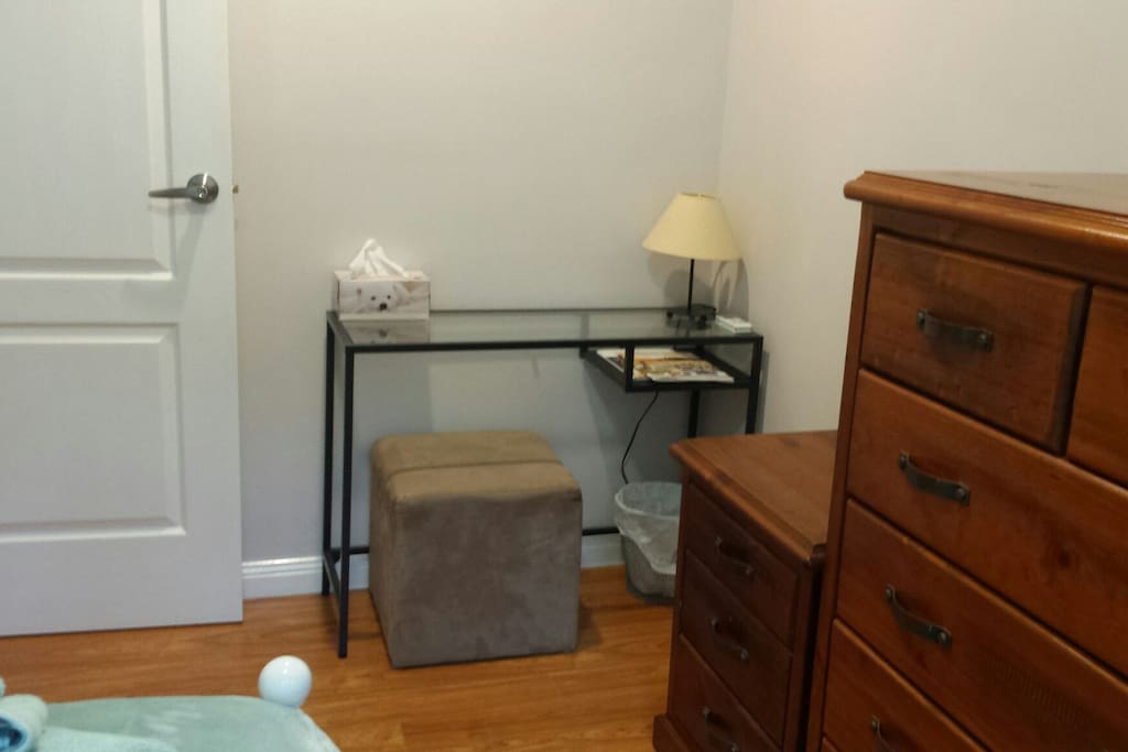 Laptop table and lamp in double room.
