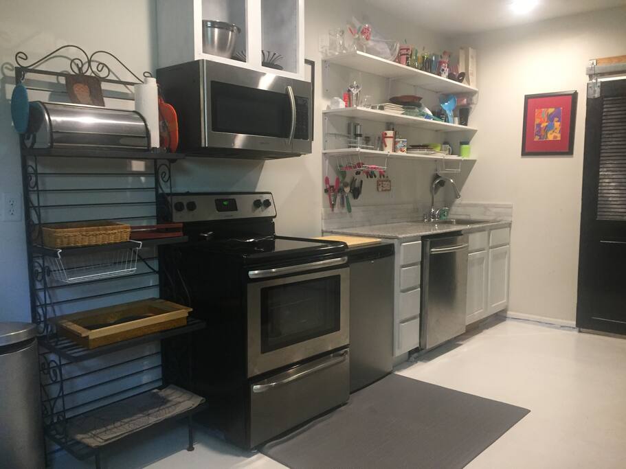 Kitchen with all dishes, silverware, cooking supplies, baker's rack for food storage
