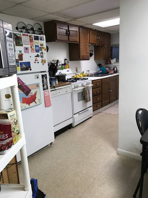 Ample kitchen with a gas stove and huge fridge.