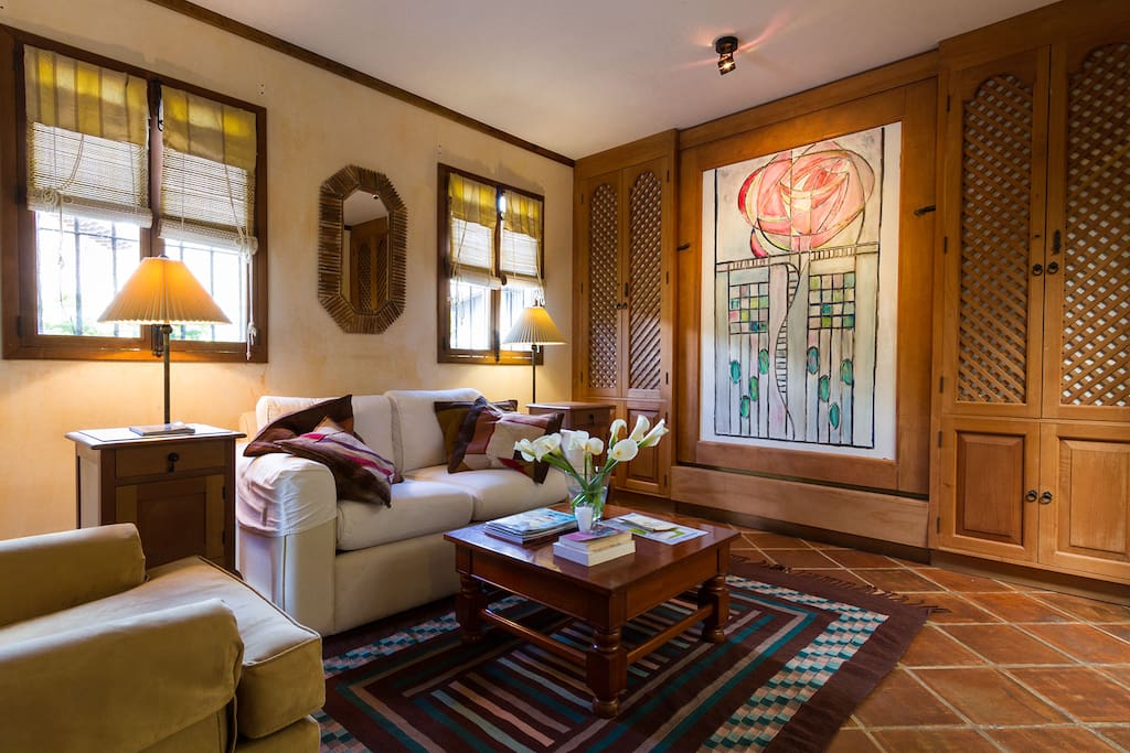 A Charles Rennie Mackintosh style rose in tempera and an original carpet made on-site liven up this living room.