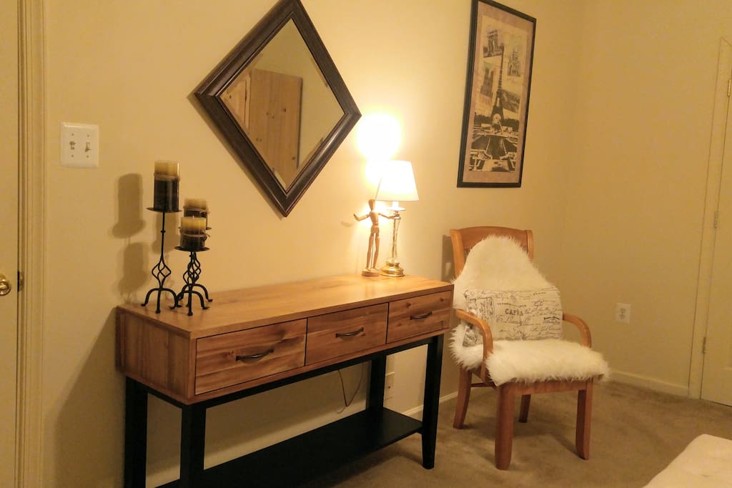 The bedroom dresser/console table, opposite the bed.