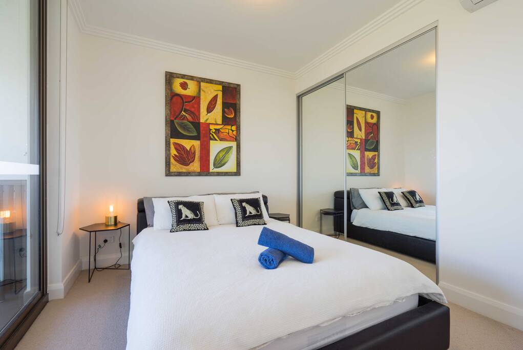 bedroom with queen size bed, hand towel, bath towels are provided