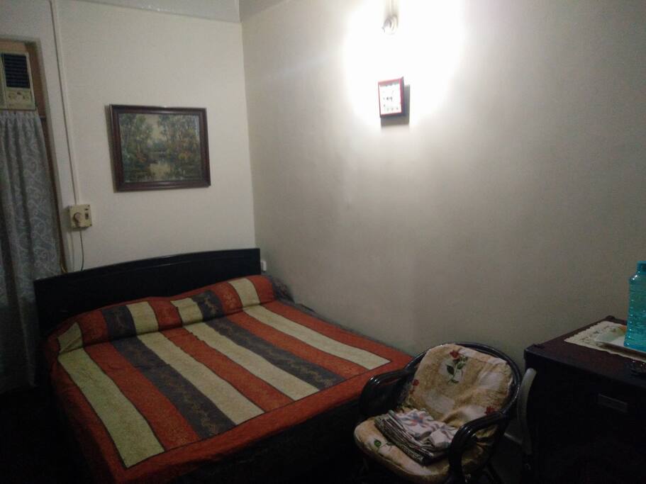 A double bed, wardrobe, fridge, & Air conditioning.