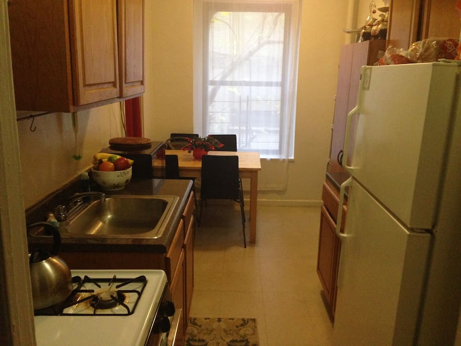 Large galley style kitchen with table, 4 chairs, and nice counter space.