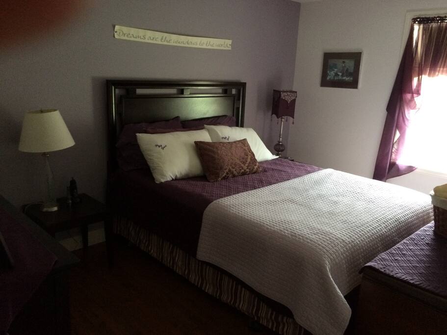 Relax in a spacious bedroom featuring a Queen size bed for your comfort