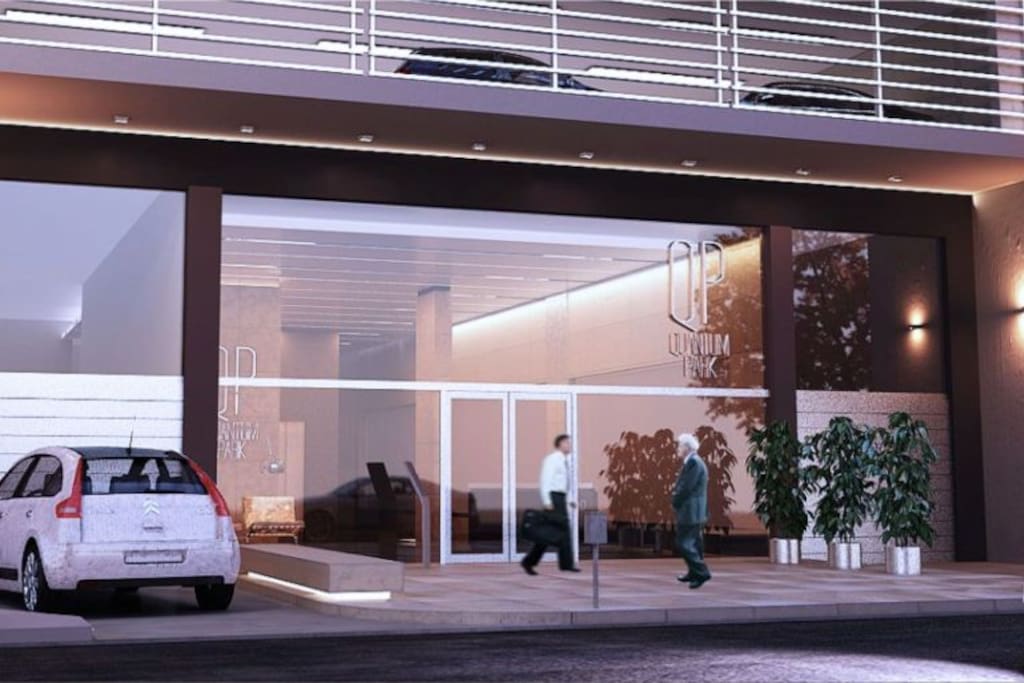 Render de entrada al edificio y entrada garage