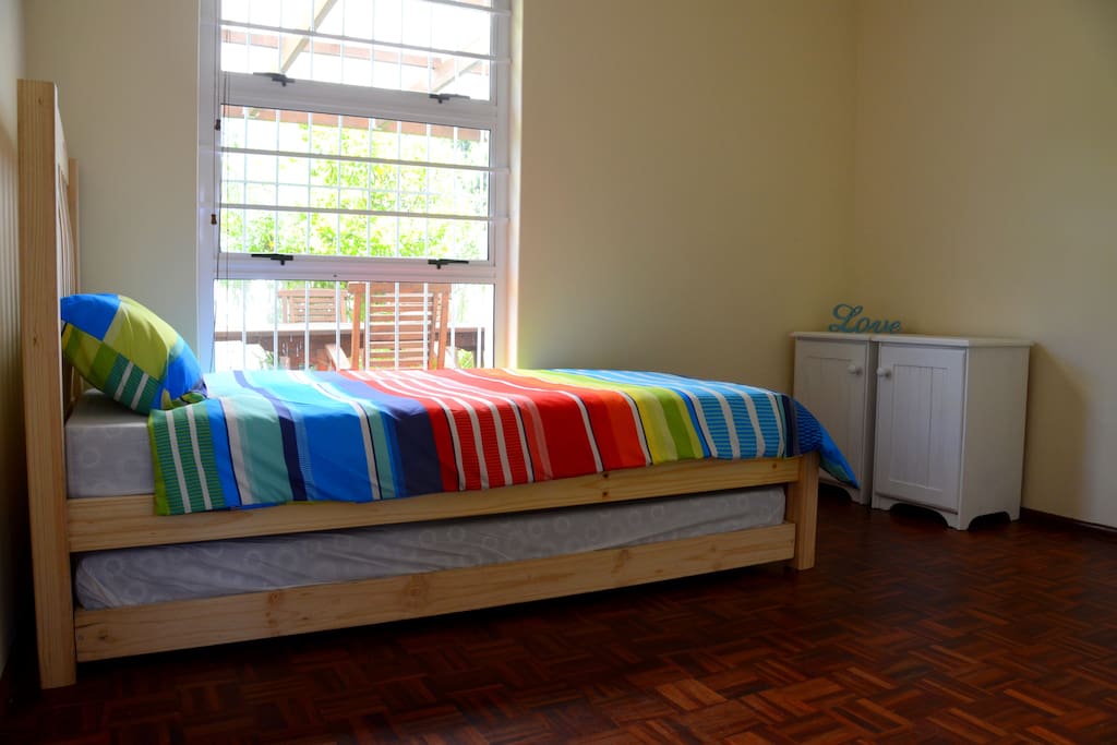 Spare bedroom with a single bed and built in cupboards
