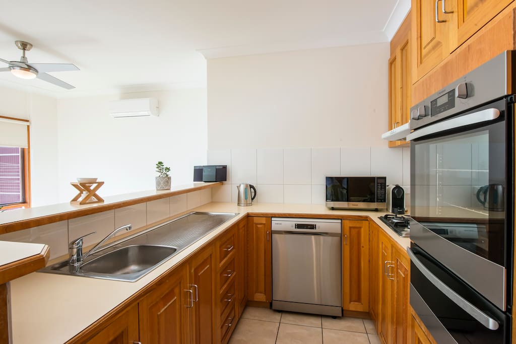 Kitchen with dishwasher, oven, microwave and coffee machine
