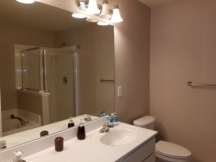 First bathroom with separate shower and tub, and double faucet.
