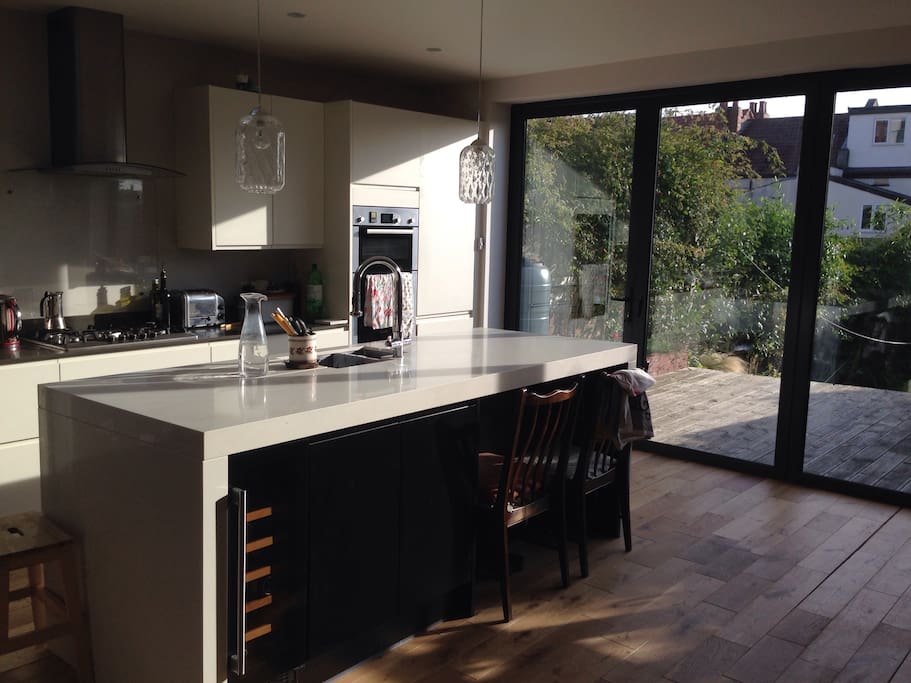 Large open plan kitchen with double oven, gas hob, tumble dryer and washing machine.