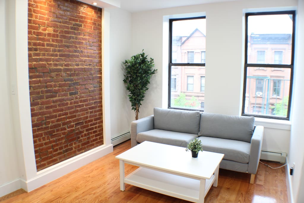 We have a pretty big living room with exposed brick for our guests