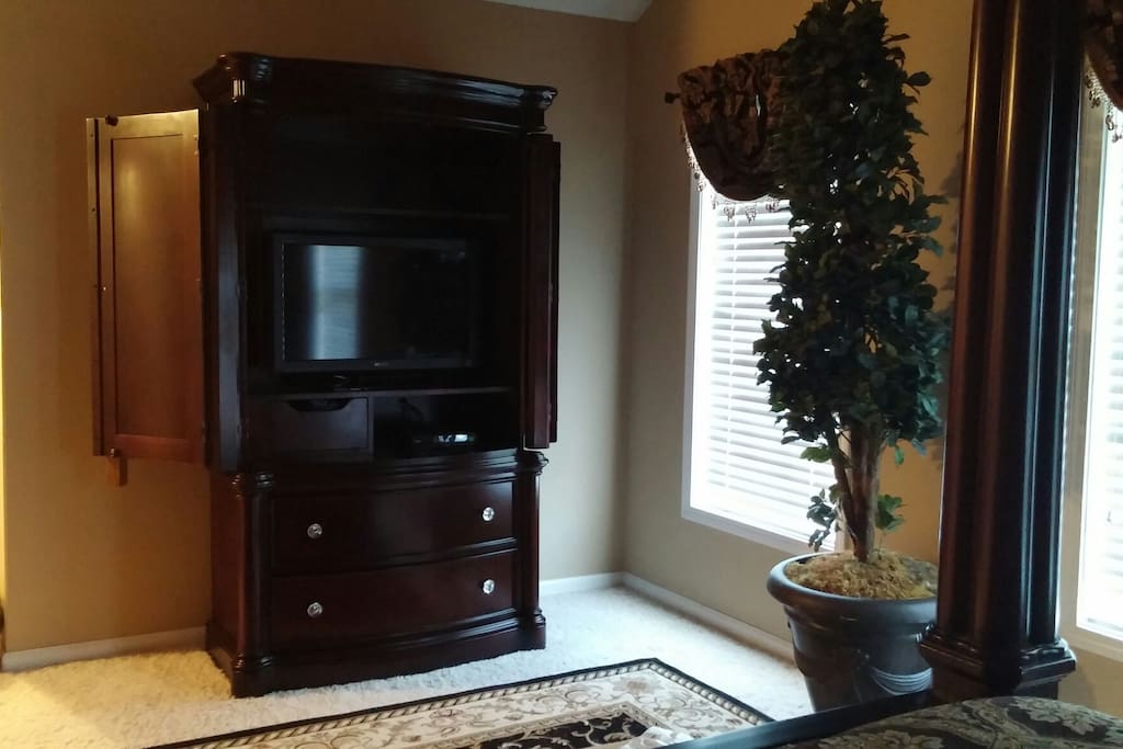 Armoire with tv and cable in master bedroom.