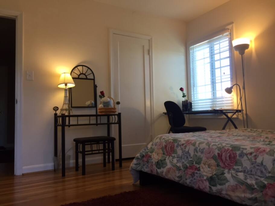 A computer table in front of a window