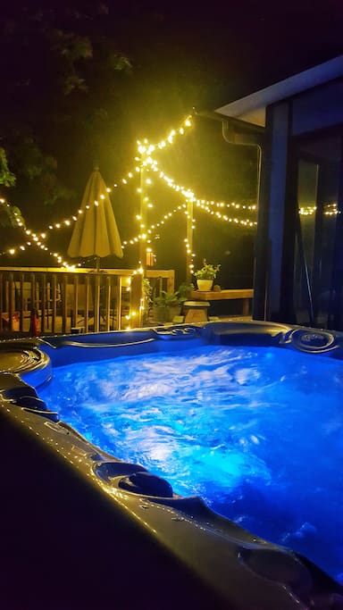 Hot Springs SIX person hot tub with water feature and adjustable colored lighting.
