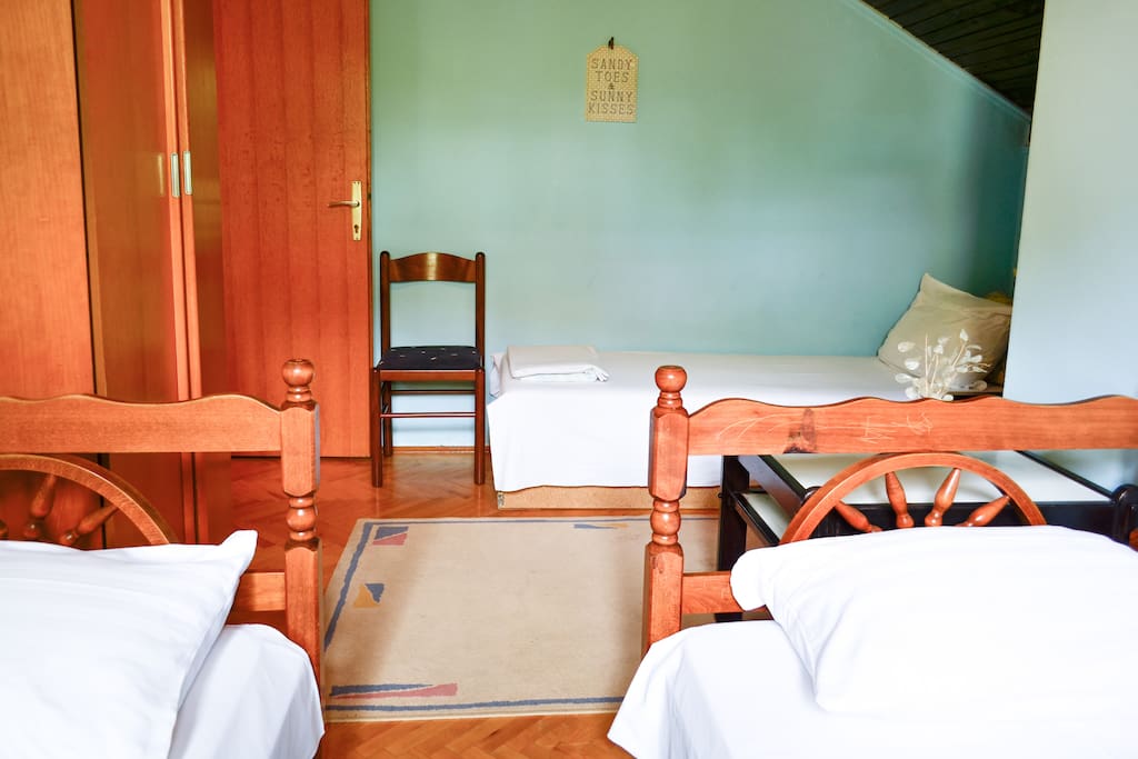 The room features three single beds.