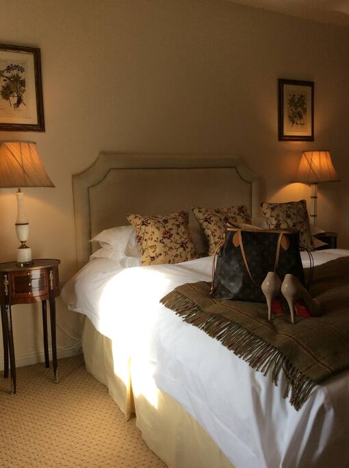 Main bedroom with king size bed, feather and down duvets and toppers and foxford blanket