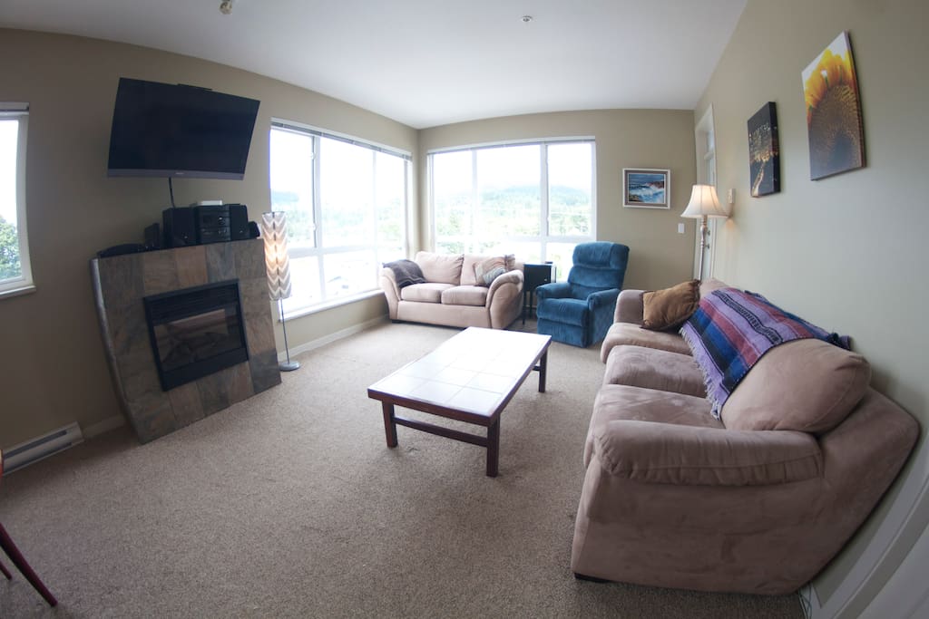 Bright and spacious living room with mountain views, and entertainment unit.