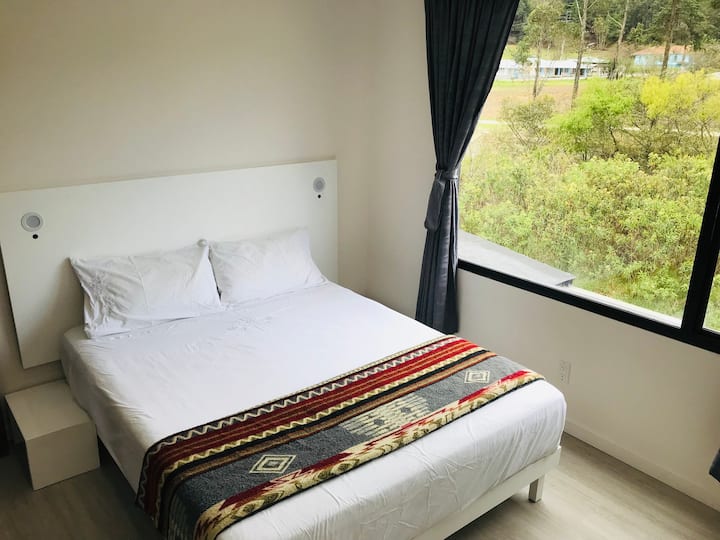 Open the window to the river sounds, just meters away. Airy bedroom with double pillow top - queen size bed.