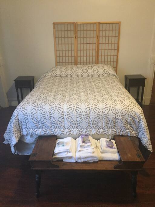 The large room has the queen size bed with extra padding.