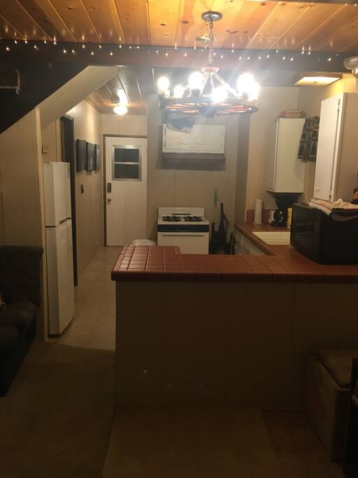 Kitchen includes stove, microwave, toaster, coffee pot, stove, and brand new fridge.