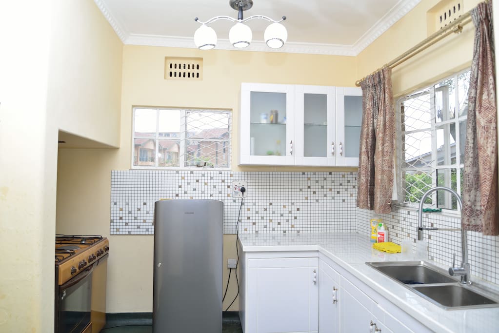 Kitchen with fridge, cooker and microwave