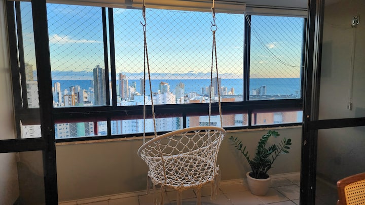 Balcony with sea view and hanging rocking chair