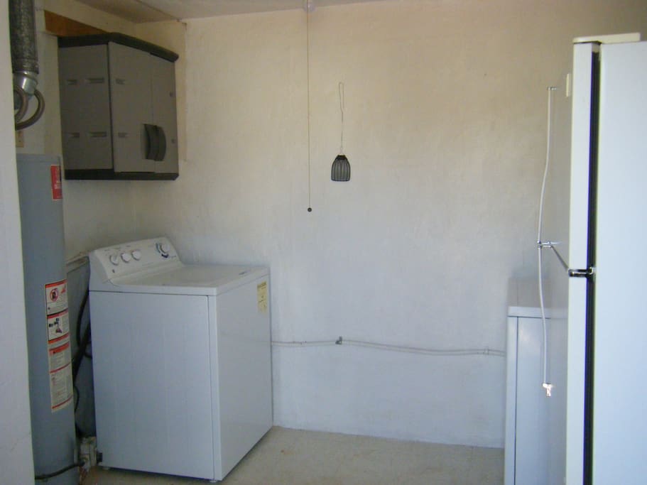 WASHER AND DRYER WITH SOAP AND SOFTENER. IRONING BOARD WITH STEAM IRON.