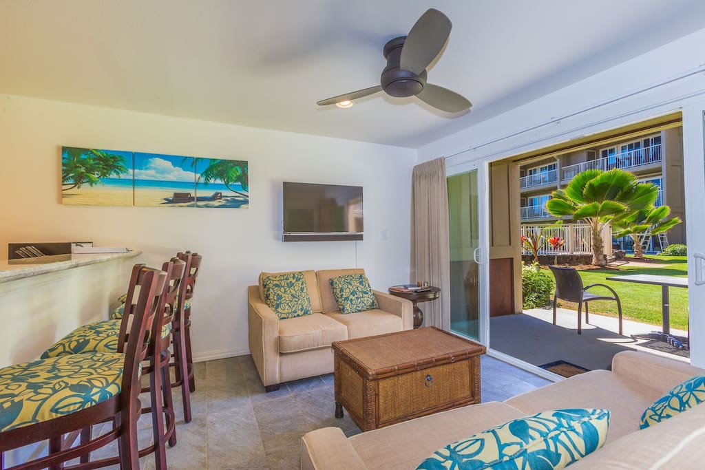 Living room with ceiling fan and open up to Lanai for wonderful living space.