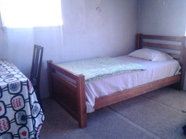 comfy bed in apartment room- Overland Park