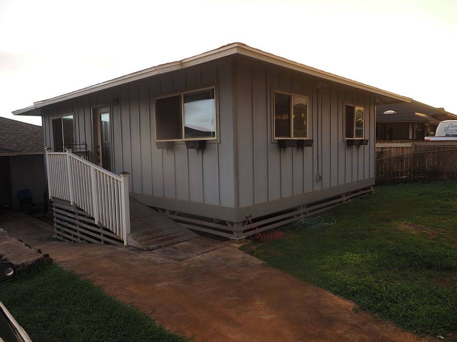 View of the front of the property, free parking available to the right on grassy area.