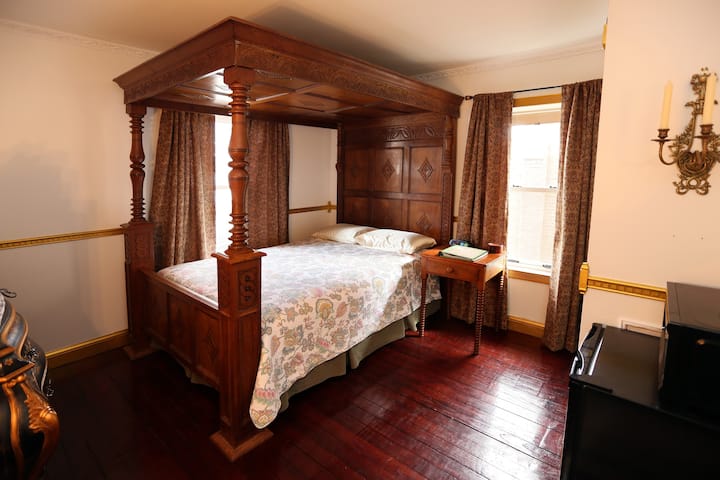 Full size antique Jacobean bed, wooden floors