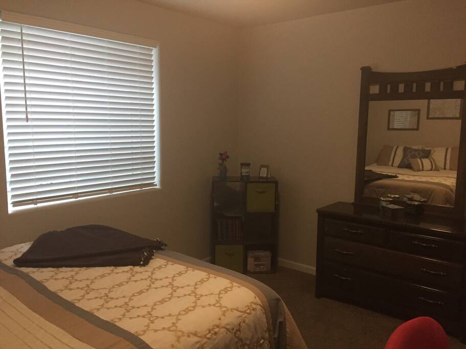 Bedroom with dresser, desk and walk-in closet