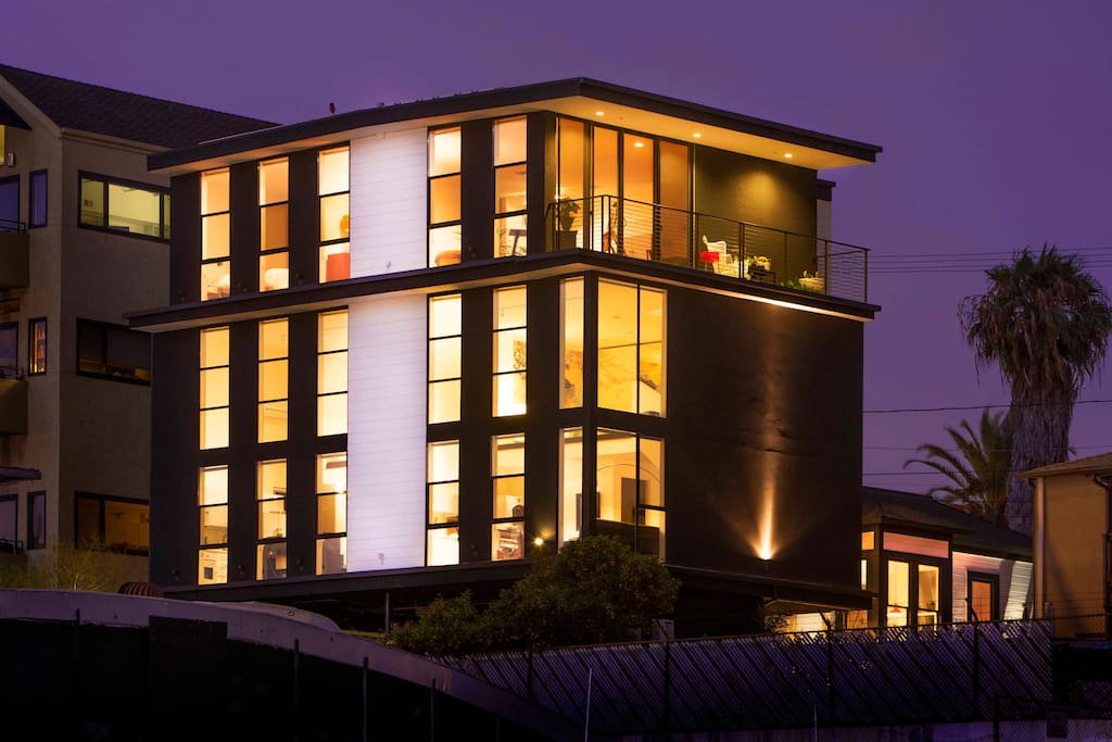 Exterior of the building at night. Penthouse occupies entire top floor of the building.
