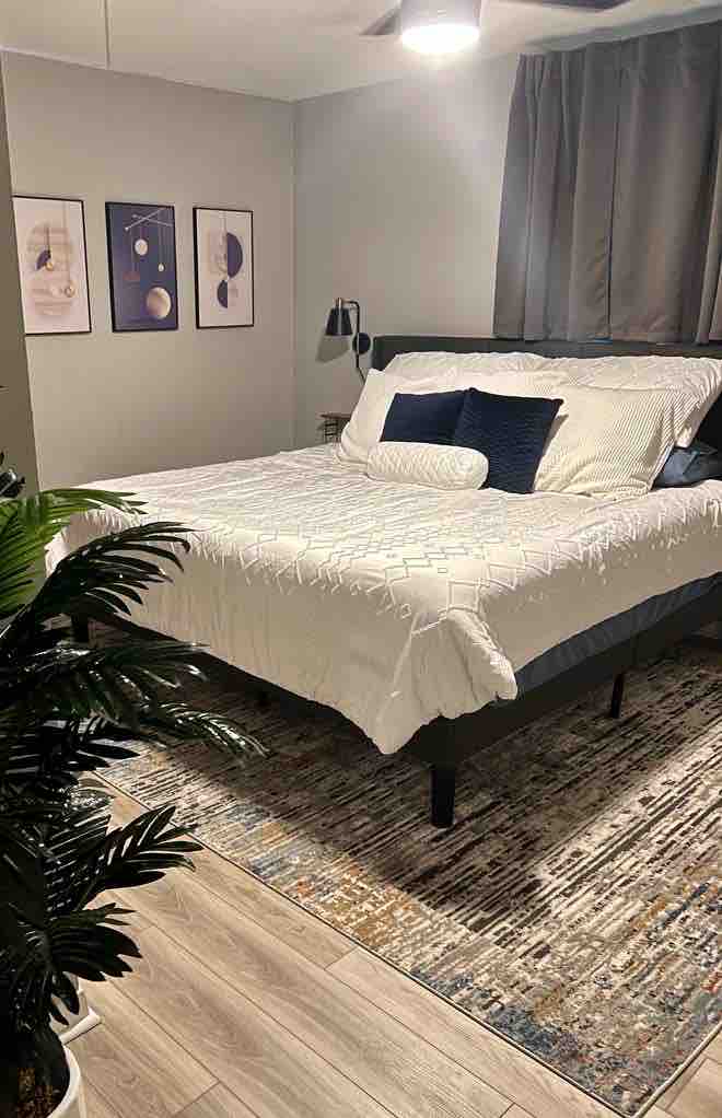 Kitanda aina ya King katika chumba cha msingi chenye bafu la chumbani. 