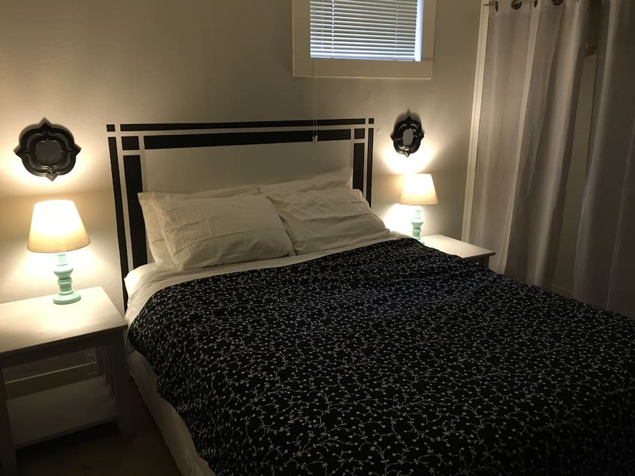 Bedroom with queen bed, desk and closet