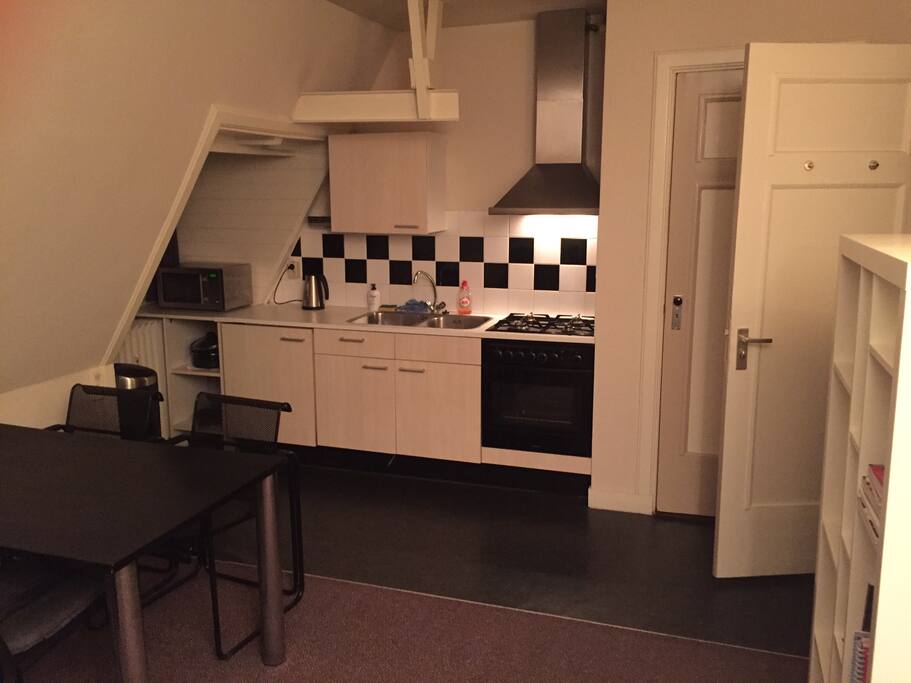 Open kitchen with oven, microwave, fridge, etc.
