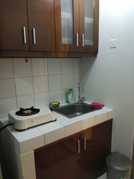 Kitchen with stove and electric kettle for hot water
