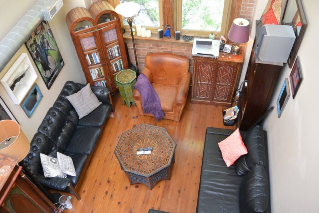 Living room space with with 2 story ceilings, with projector TV .