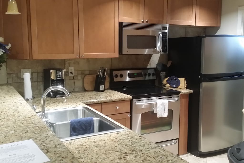 Full kitchen with pots , pans, toaster , microwave, blender, plates, cutlery, block knives, dishwasher, disposal, coffee maker, ice maker fridge -freezer, and more.