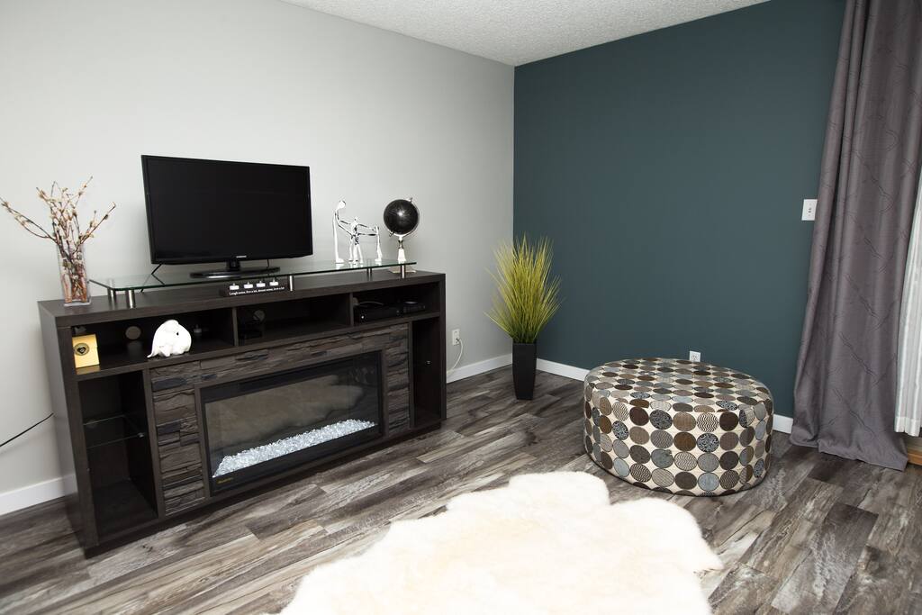 Watch Apple TV, in your cozy living room with warmth from the electric fireplace.