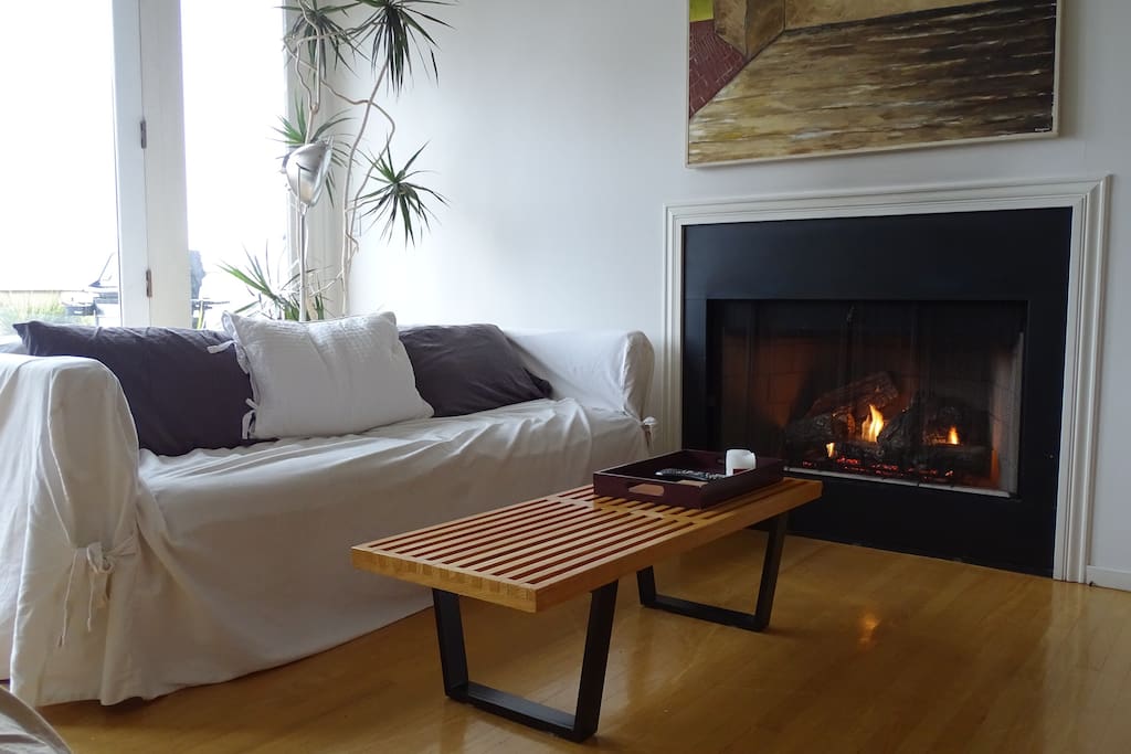 Living area with cozy gas fireplace and bay views.